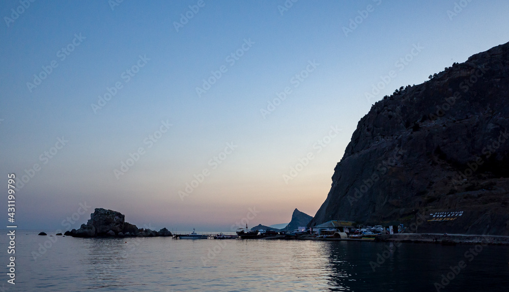 Sailing boats at the pier at the foot of the Fortress Mountain in Sudak.