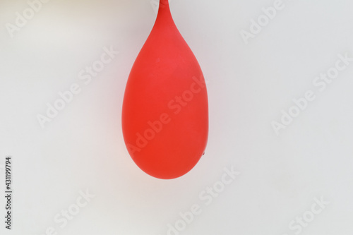 picture of red balloon filled with water and hanging
