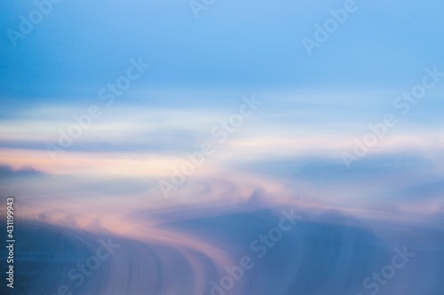 abstract blue and pink background like sunset swirling through a valley