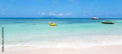 Landscape summer beach background, with sunny sky and blue water, banner