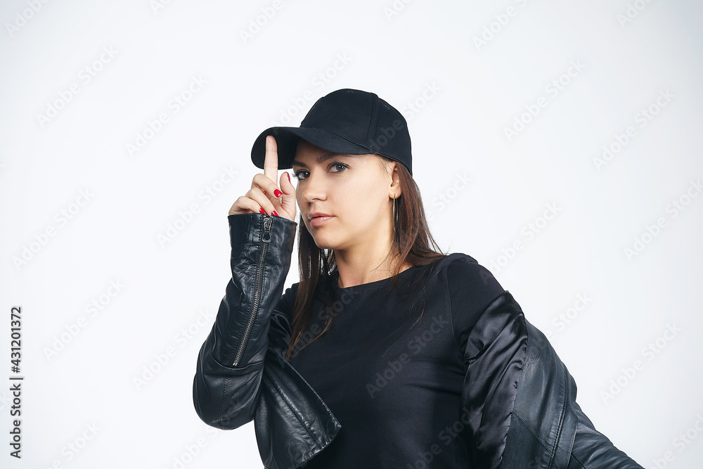 attractive girl in a black jacket and cap. photo session in the studio attractive girl in a black jacket and cap. photo session in the studio