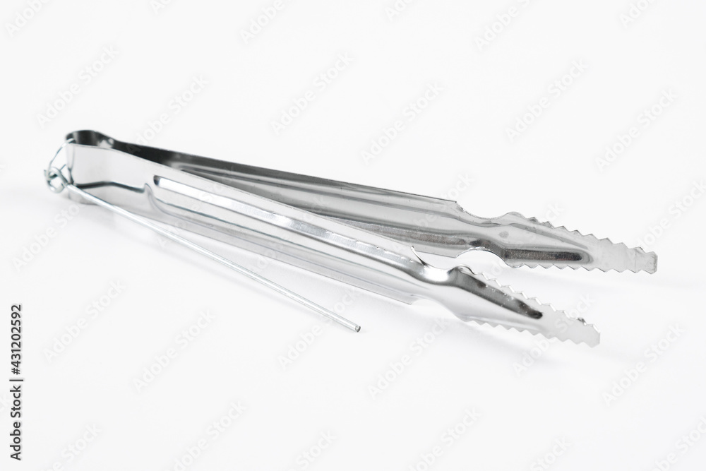 Metal hookah tongs on a white background.