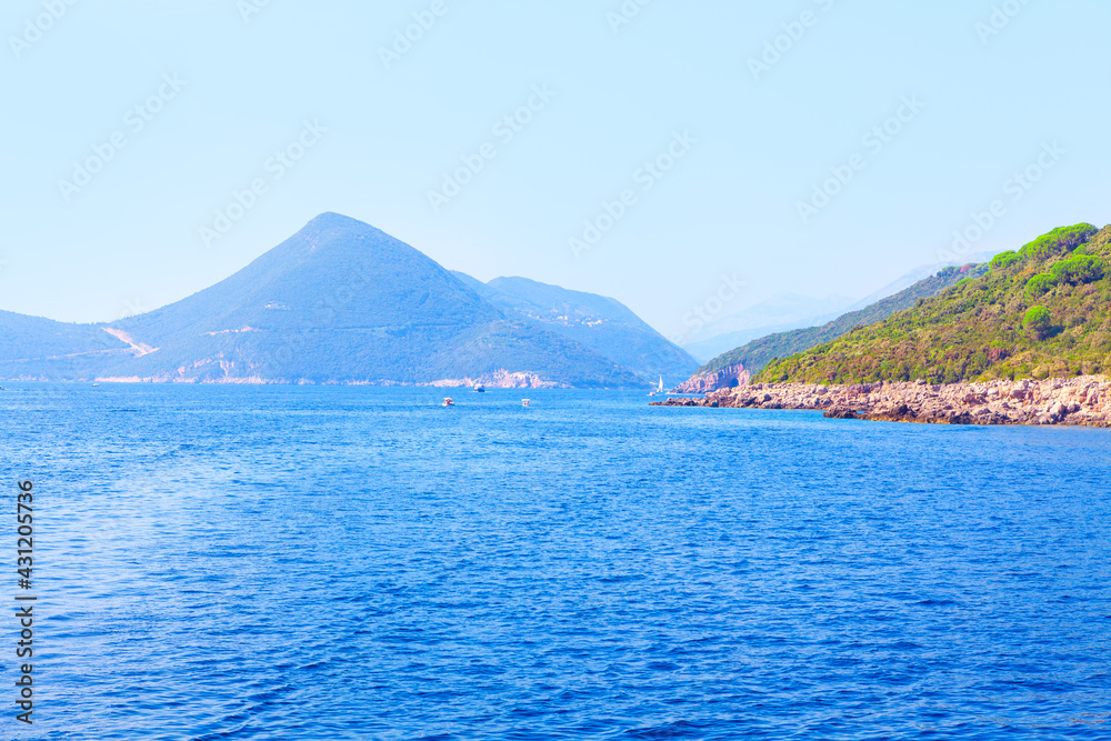 Blue bay with mountains . Kotor Bay with sailing boats . Coastal Balkans mountains 