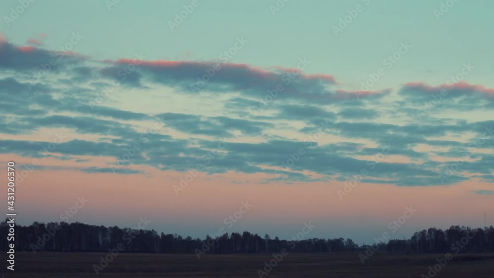 Running clouds over the field and forest at sunset. Running clouds over the field and forest at sunset.