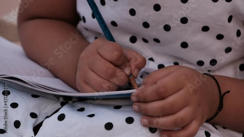 Little girl studying or writing at home