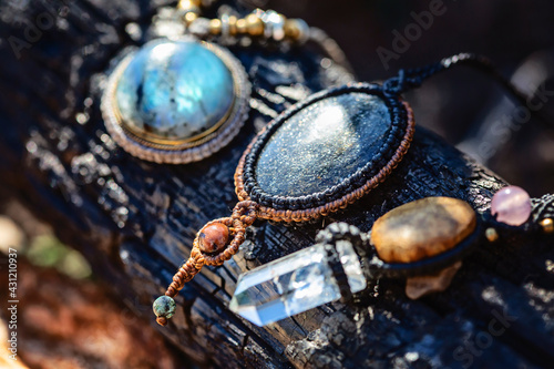 Collection of mineral gemstones jewelry necklaces on natural woody background