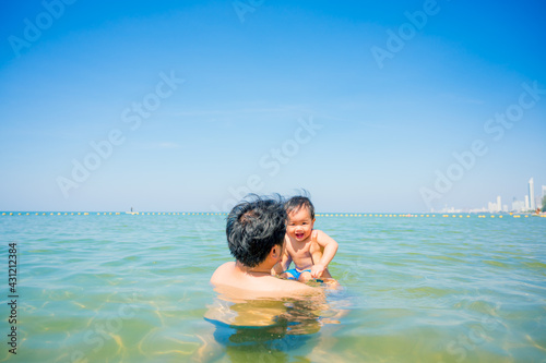 Happy family resting at beach in summer, Father and baby © grooveriderz
