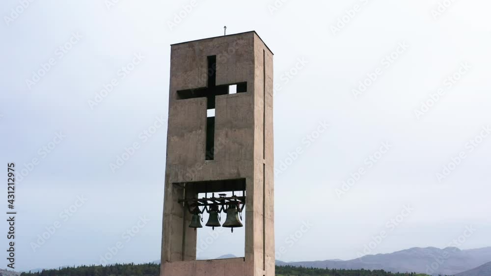Cross as religious sign on the concrete bell tower of a modern catholic Christian church. Crucifix is symbol of faith in god and Jesus Christ Cross as religious sign on the concrete bell tower of a modern catholic Christian church. Crucifix is symbol of faith in god and Jesus Christ