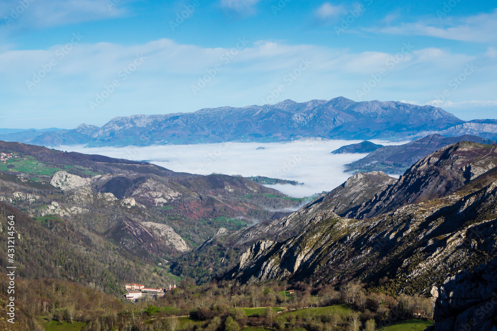 Landscape of a sea of ​​clouds and the Basilica of Covadonga in the background in the mountains of the Lakes of Covadonga.The photograph is taken in horizontal format.