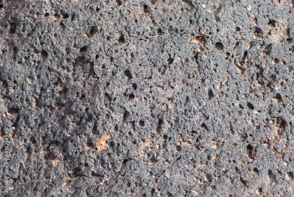 Close-up grunge black stone or rock texture in nature park of Jandia on deserted island Fuerteventura Close-up grunge black stone or rock texture in nature park of Jandia on deserted island Fuerteventura