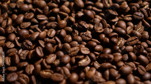 A Pile of Brown Arabica Coffee Beans in the Dark Background
