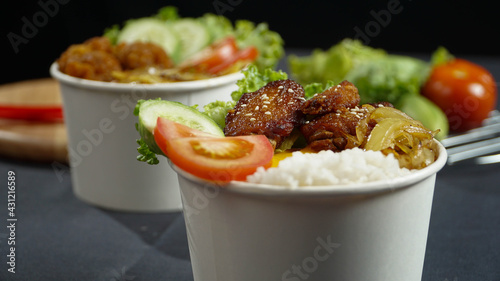 Healthy fresh rice bowls with tomato green cuisine and fried chicken wings in dark background