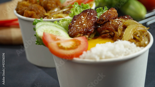 Healthy fresh rice bowls with tomato green cuisine and fried chicken wings in dark background