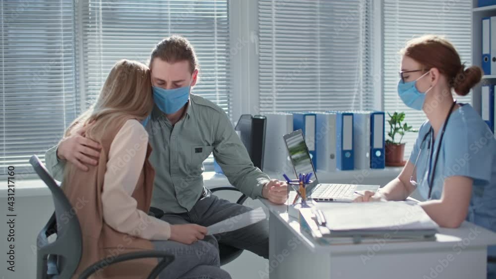 man and wife in medical masks are upset and discouraged due to poor ...