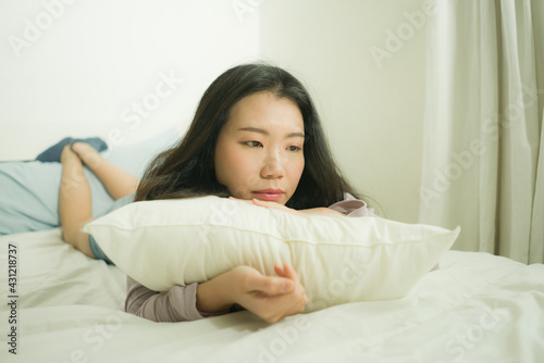 young Asian woman depressed - young beautiful and sad  Chinese girl on bed with pillow feeling unhappy and broken heart suffering depression problem at home bedroom