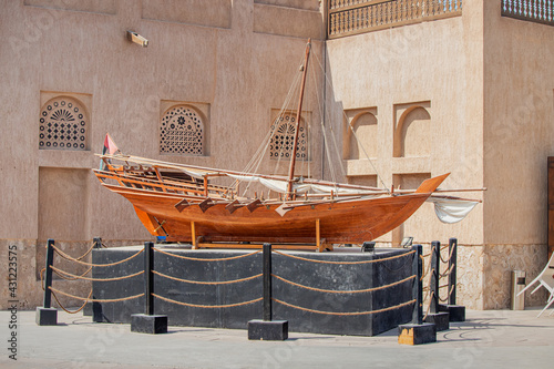 Ancient wooden Arba Dhow rowing boat on a pedestal near the museum in Dubai Creek photo