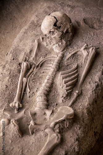 Human remains of ancient roman soldier on archaeological site excavated skeleton