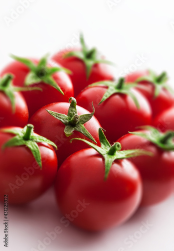 Tomatoes stacked vibrant  fresh large ready to eat kitchen arrangement isolated on white with copy space selective focus studio shot
