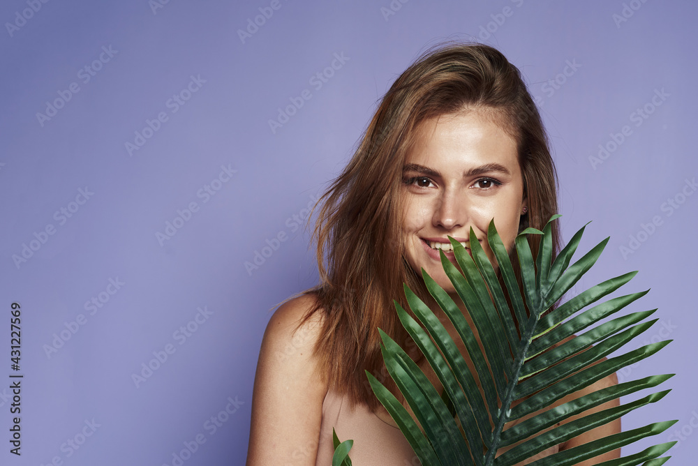 Cheerful pretty woman charm smile palm leaves. Leaf Of Palm Behind Model. Beautiful. Organic Cosmetic And SPA Treatment For Healthy Hydrated Facial Skin