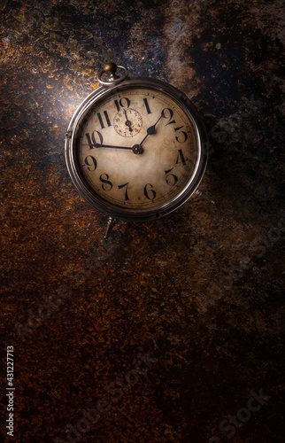 Old clock overhead rustic arrangement on dark vibrant background with copy space low light studio shot