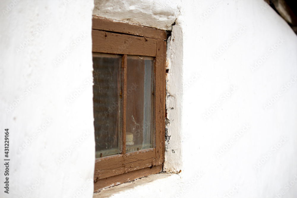 brown barn window in white wall