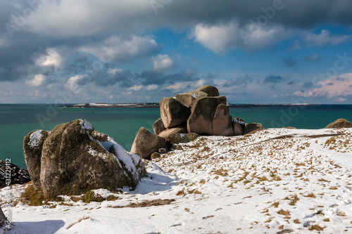 A rare fall of snow on Peninnis Head, St. Mary's, Isles of Scilly, UK, with Gugh and St. Agnes across St. Mary's Sound photo