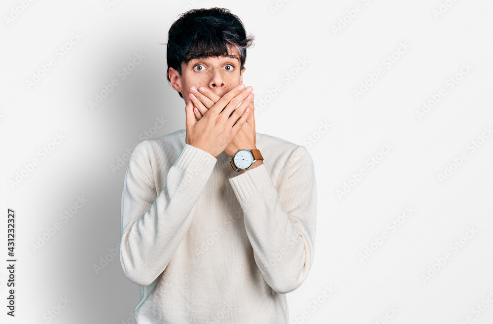 Handsome hipster young man wearing casual winter sweater shocked covering mouth with hands for mistake. secret concept. Handsome hipster young man wearing casual winter sweater shocked covering mouth with hands for mistake. secret concept.