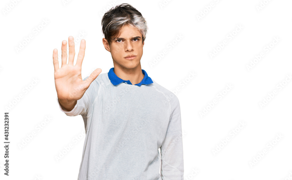 Young hispanic man wearing casual clothes doing stop sing with palm of the hand. warning expression with negative and serious gesture on the face. Young hispanic man wearing casual clothes doing stop sing with palm of the hand. warning expression with negative and serious gesture on the face.