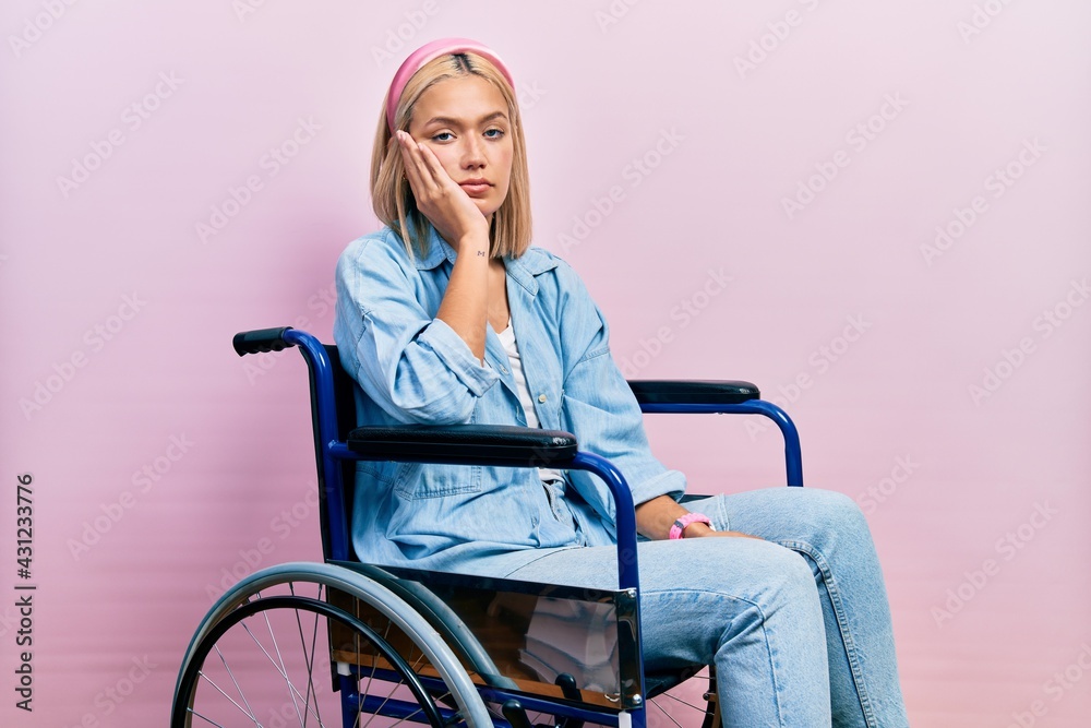Beautiful blonde woman sitting on wheelchair thinking looking tired and bored with depression problems with crossed arms. Beautiful blonde woman sitting on wheelchair thinking looking tired and bored with depression problems with crossed arms.