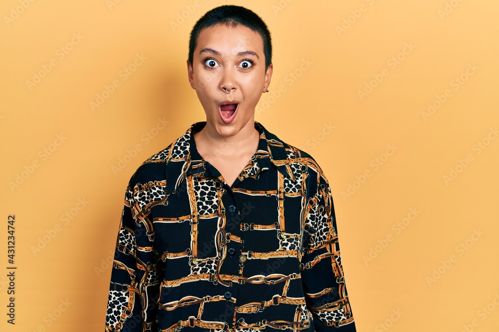 Beautiful hispanic woman with short hair wearing elegant shirt scared and amazed with open mouth for surprise, disbelief face Beautiful hispanic woman with short hair wearing elegant shirt scared and amazed with open mouth for surprise, disbelief face
