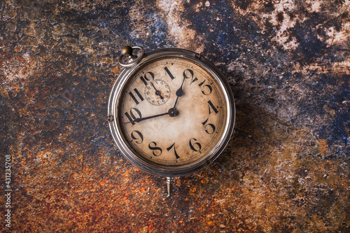 Old clock rustic arrangement overhead on vibrant color background studio shot