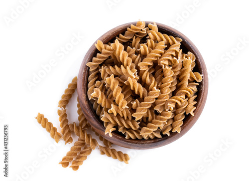 Принти на полотні Whole grain fusilli in wooden bowl isolated on white