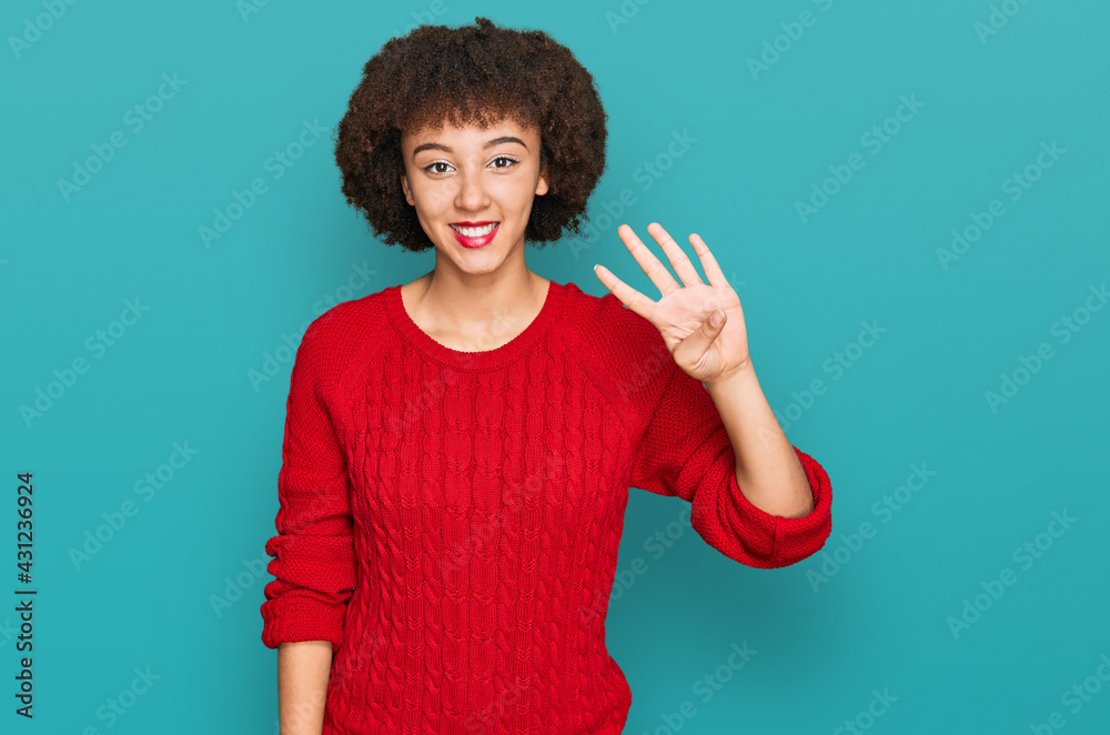 Young hispanic girl wearing casual clothes showing and pointing up with fingers number four while smiling confident and happy.