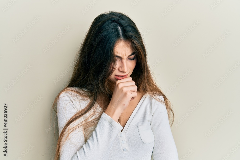 Young caucasian woman wearing casual white t shirt feeling unwell and coughing as symptom for cold or bronchitis. health care concept. Young caucasian woman wearing casual white t shirt feeling unwell and coughing as symptom for cold or bronchitis. health care concept.