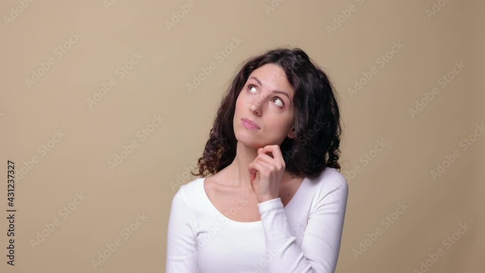 Pensive young lady of 30s thinking, thoughtful rub chin and scratch hair while pondering over new idea, decision or solution with cunning smile isolated over beige background. Studio closeup portrait Pensive young lady of 30s thinking, thoughtful rub chin and scratch hair while pondering over new idea, decision or solution with cunning smile isolated over beige background. Studio closeup portrait