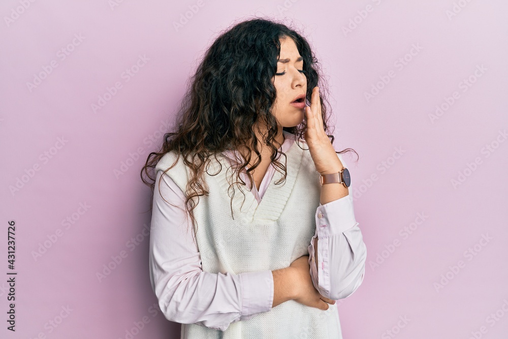 Young brunette woman with curly hair wearing casual clothes bored yawning tired covering mouth with hand. restless and sleepiness. Young brunette woman with curly hair wearing casual clothes bored yawning tired covering mouth with hand. restless and sleepiness.