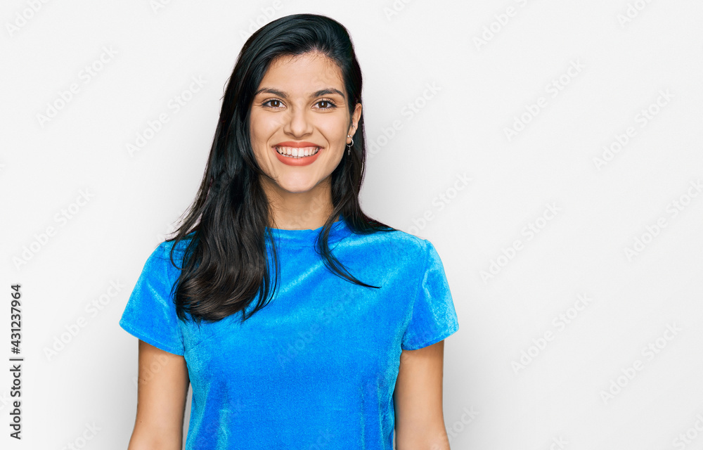 Young hispanic woman wearing casual clothes with a happy and cool smile on face. lucky person. Young hispanic woman wearing casual clothes with a happy and cool smile on face. lucky person.