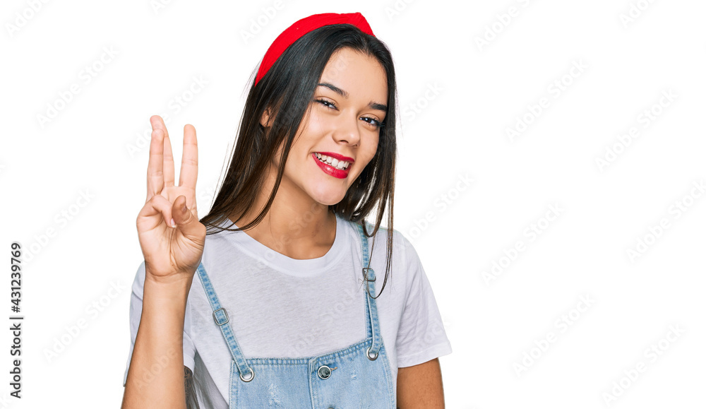 Young hispanic girl wearing casual clothes showing and pointing up with fingers number three while smiling confident and happy. Young hispanic girl wearing casual clothes showing and pointing up with fingers number three while smiling confident and happy.