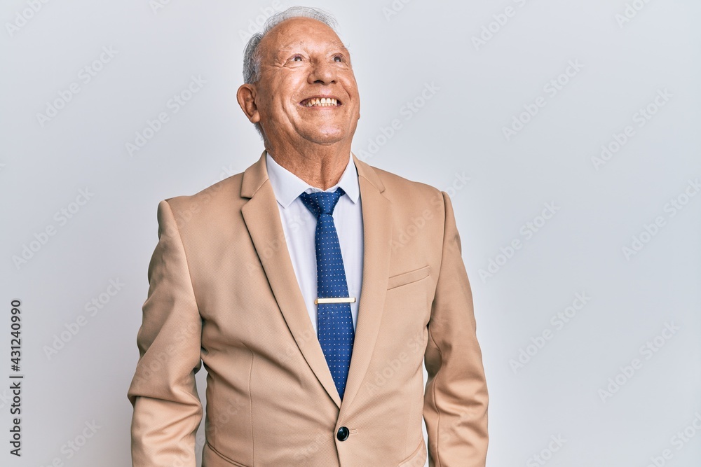 Senior caucasian man wearing business suit looking to side, relax profile pose with natural face and confident smile. Senior caucasian man wearing business suit looking to side, relax profile pose with natural face and confident smile.