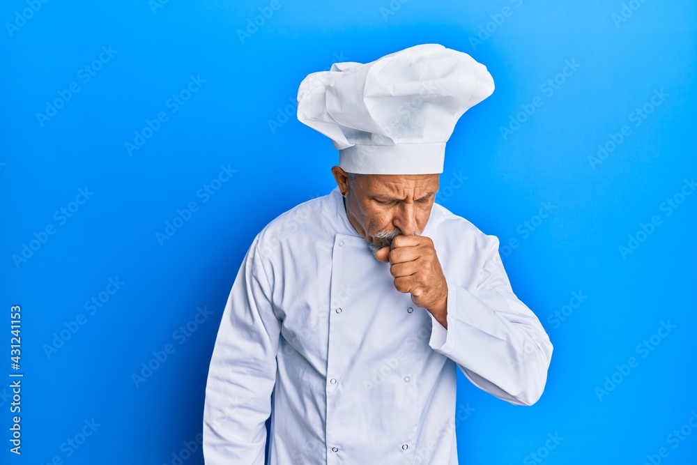 Middle age grey-haired man wearing professional cook uniform and hat feeling unwell and coughing as symptom for cold or bronchitis. health care concept. Middle age grey-haired man wearing professional cook uniform and hat feeling unwell and coughing as symptom for cold or bronchitis. health care concept.