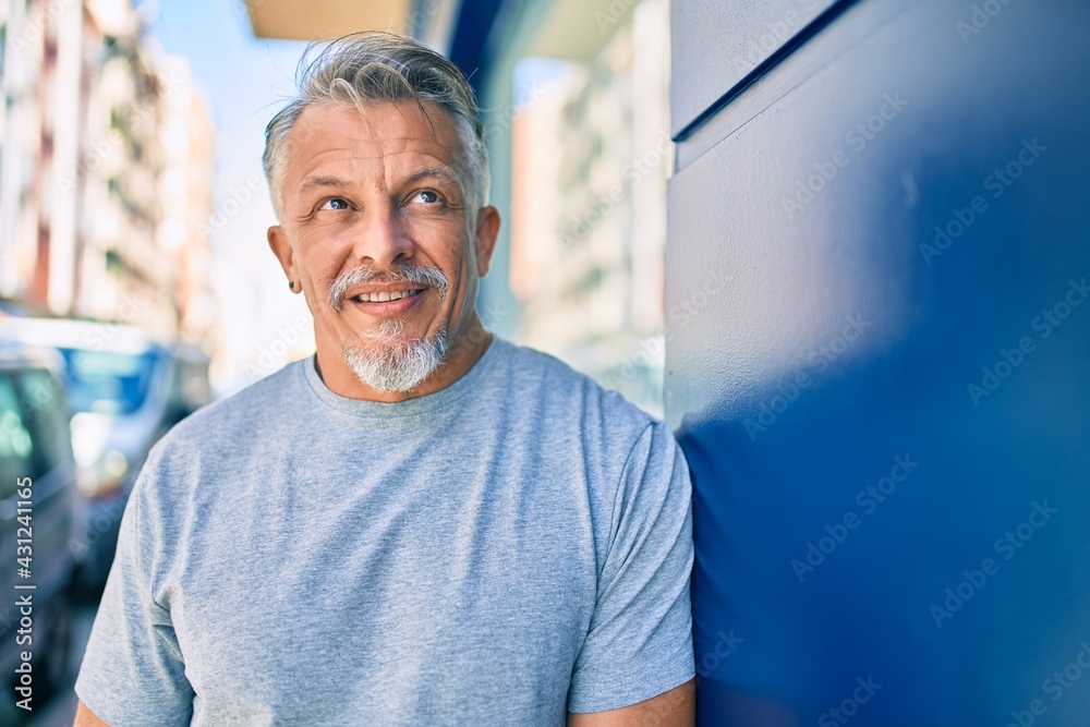 Middle age hispanic grey-haired man smiling happy standing at the city. Middle age hispanic grey-haired man smiling happy standing at the city.