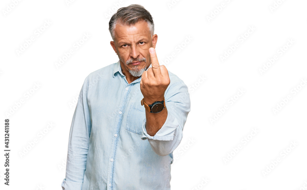 Middle age grey-haired man wearing casual clothes showing middle finger, impolite and rude fuck off expression Middle age grey-haired man wearing casual clothes showing middle finger, impolite and rude fuck off expression