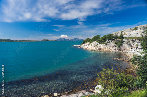 Rocky seashore with clear water and sunny weather. Beautiful nature of Norway. Picturesque Scandinavian landscape. Lofoten islands, Europe stock photo