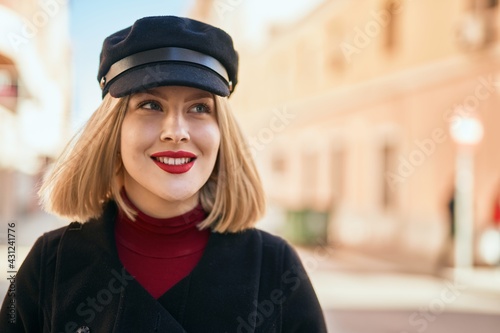 Young blonde woman smiling happy standing at the city. © Krakenimages.com