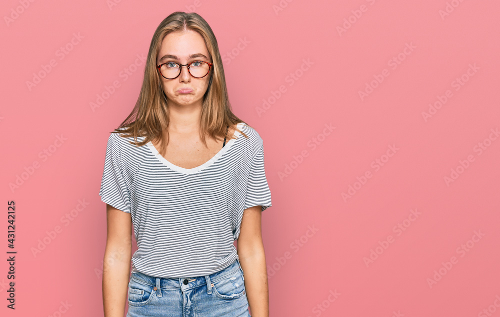 Beautiful young blonde woman wearing casual clothes and glasses depressed and worry for distress, crying angry and afraid. sad expression. Beautiful young blonde woman wearing casual clothes and glasses depressed and worry for distress, crying angry and afraid. sad expression.