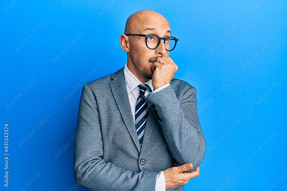 Bald man with beard wearing business jacket and glasses looking stressed and nervous with hands on mouth biting nails. anxiety problem. Bald man with beard wearing business jacket and glasses looking stressed and nervous with hands on mouth biting nails. anxiety problem.