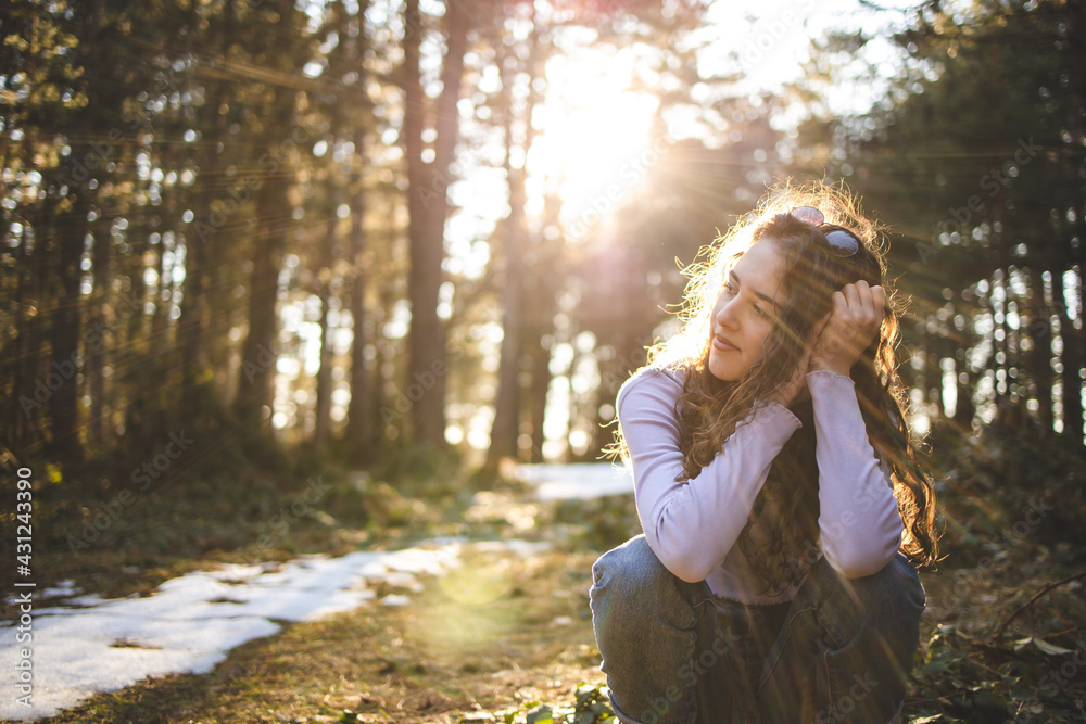 Young, brunette girl sitting in the forest Young, brunette girl sitting in the forest