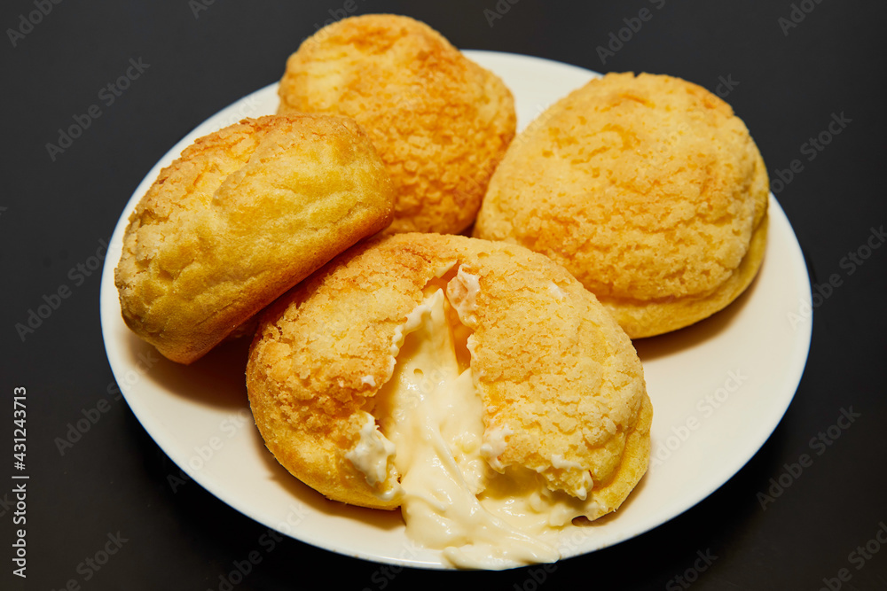 Delicious cream-filled muffins, where a muffin is open with the cream coming out