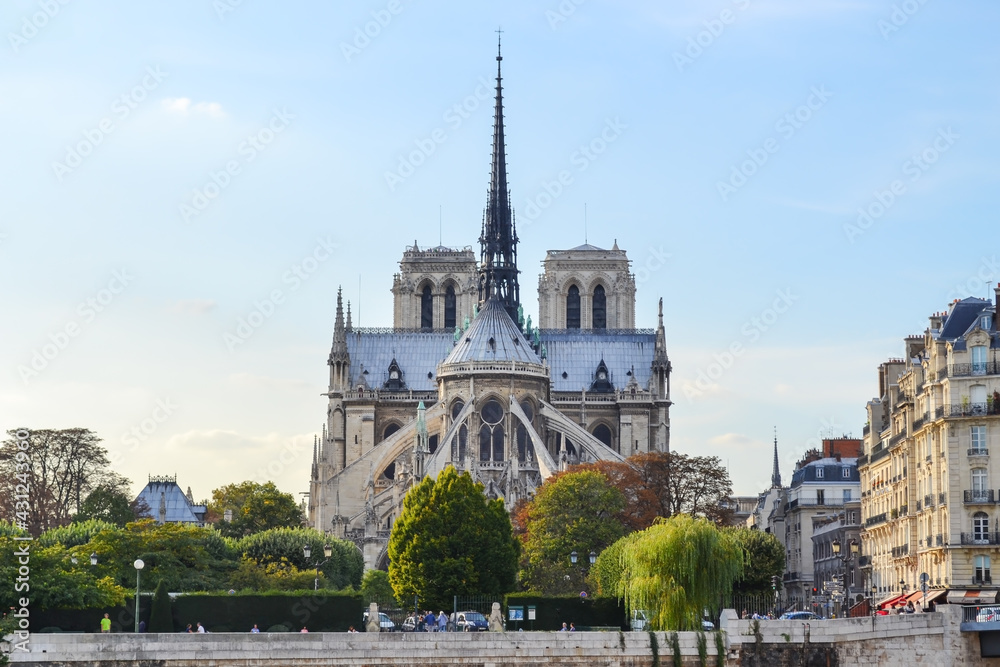 Rear view from Notre Dame Cathedral with spire in Paris, across Sena river, with blue and warn sky and almost no clouds Rear view from Notre Dame Cathedral with spire in Paris, across Sena river, with blue and warn sky and almost no clouds