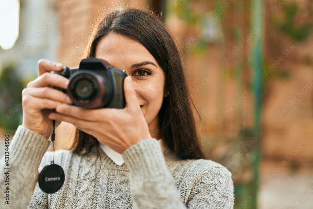 Young hispanic woman smiling happy using camera at the city. Young hispanic woman smiling happy using camera at the city.